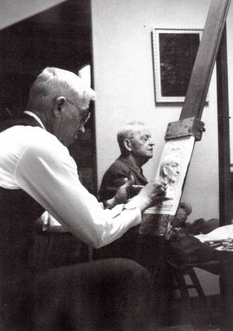 Sculptor Bruce Moore at work on bas-relief portrait of Robert Aitchison