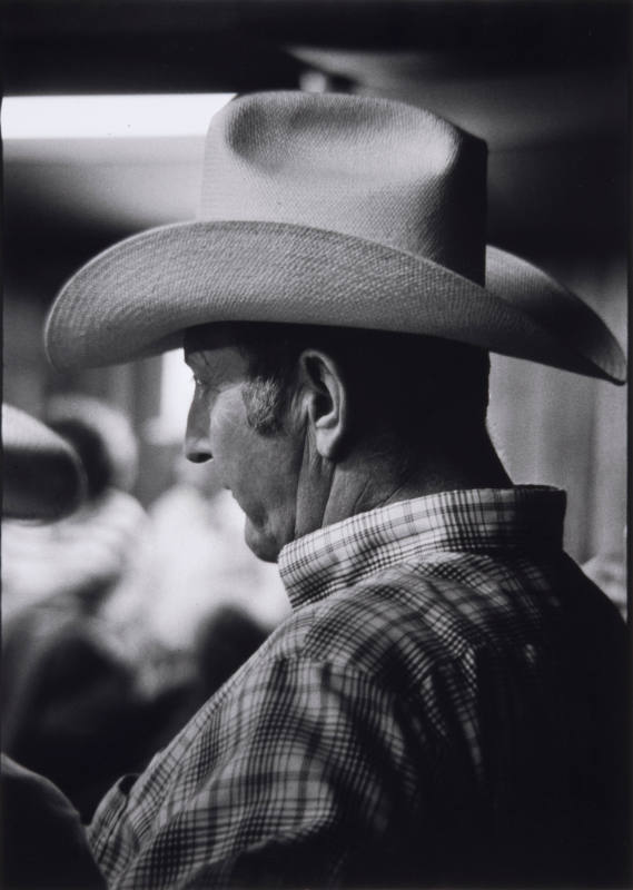 TItle unknown (profile of man in plaid shirt and western hat)