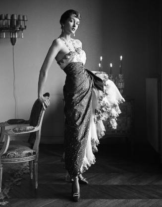 Patrician: Comtesse Alain de la Falaise, noted in Parisian society for her slim figure, patronizes Schiaparelli. Here she wears exotic cotton evening dress reminiscent of styles in the late 20s (Maxime de la Falaise)