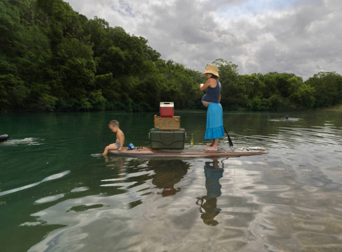 Julie Blackmon, Paddleboard, 2022, archival pigment print, 44 x 58 5/16 in., Kansas State Unive…