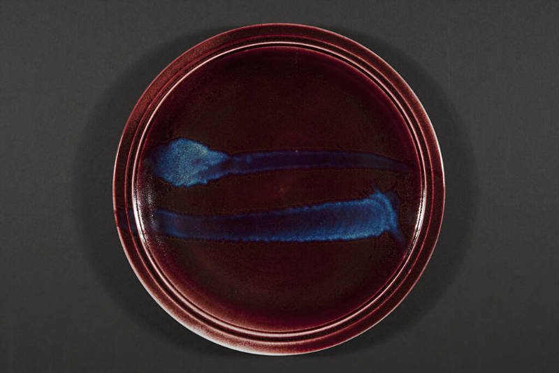 Title unknown (large burgundy plate with blue stripes)